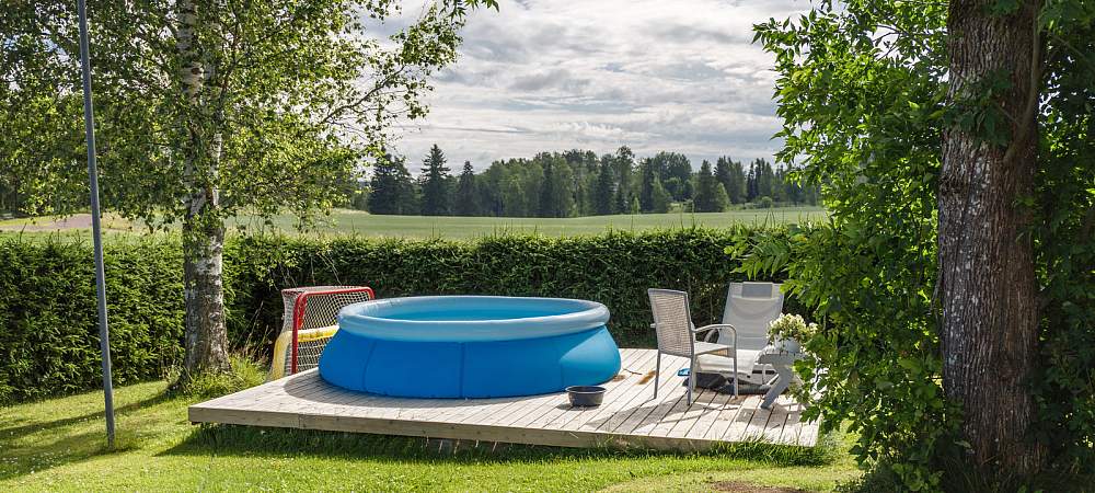 Finnish country house yard. Playground. Children's playhouse. Inflatable pool in the yard. 
- © Shutterstock