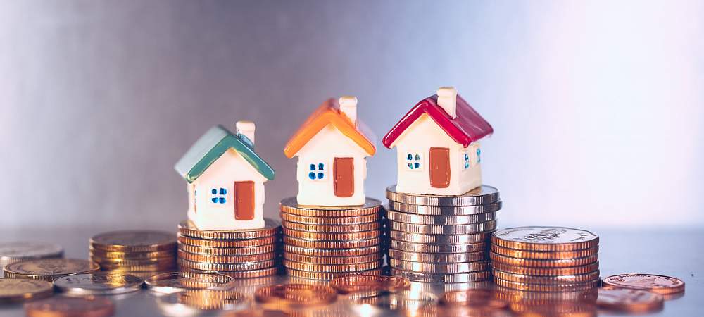 Miniature colorful house on stack coins using as property and financial concept - © Shutterstock